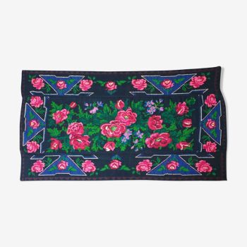 Handwoven floral wool rug, black background with pink roses