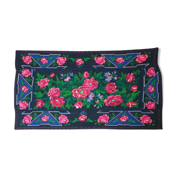 Handwoven floral wool rug, black background with pink roses