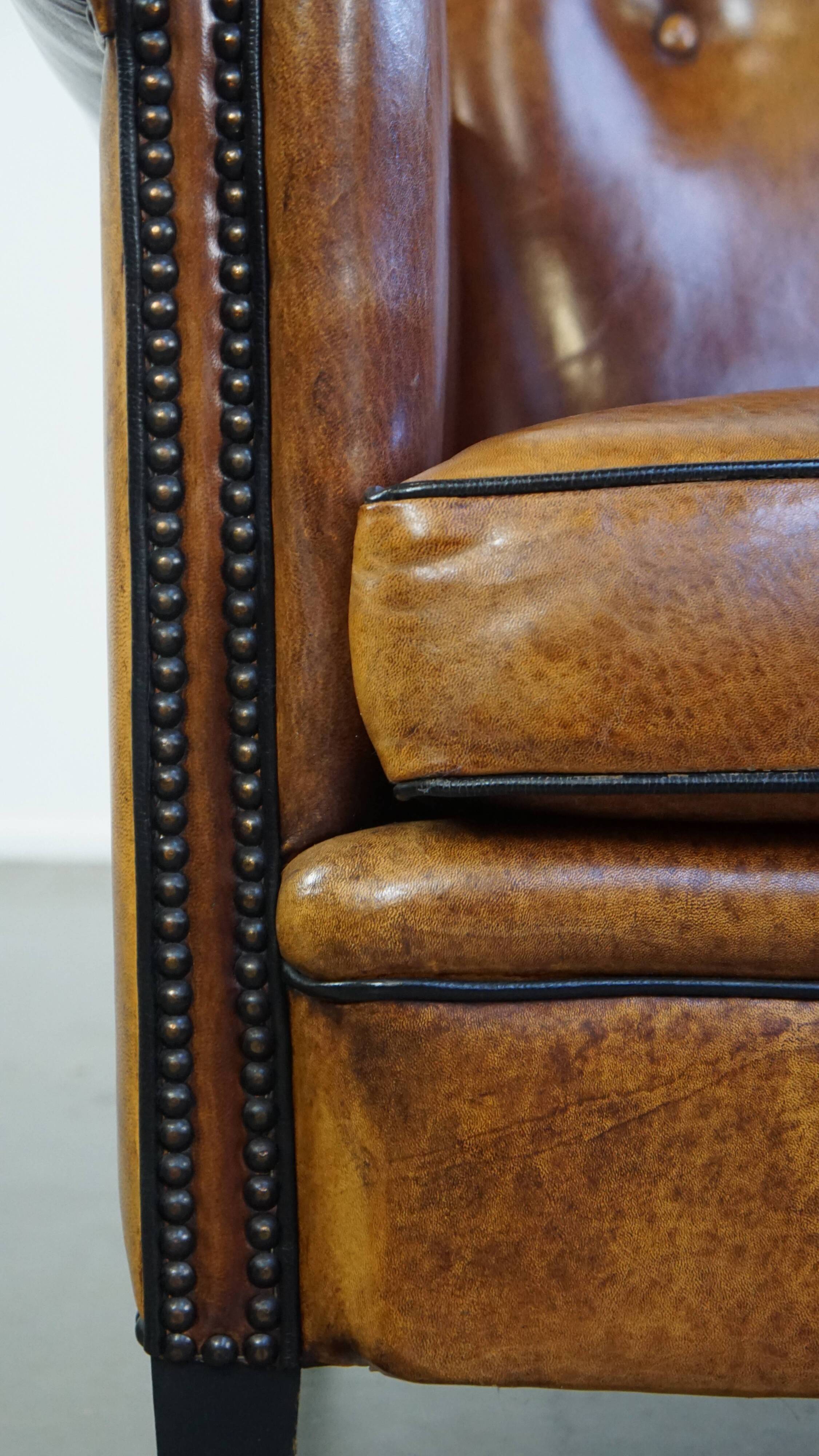 Sheep leather design armchair finished with decorative nails and black piping