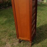 Tall chest of drawers in wood and rattan with splayed legs