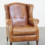 Graceful, stylish, timeless and comfortable wing chair made of cowhide in English style