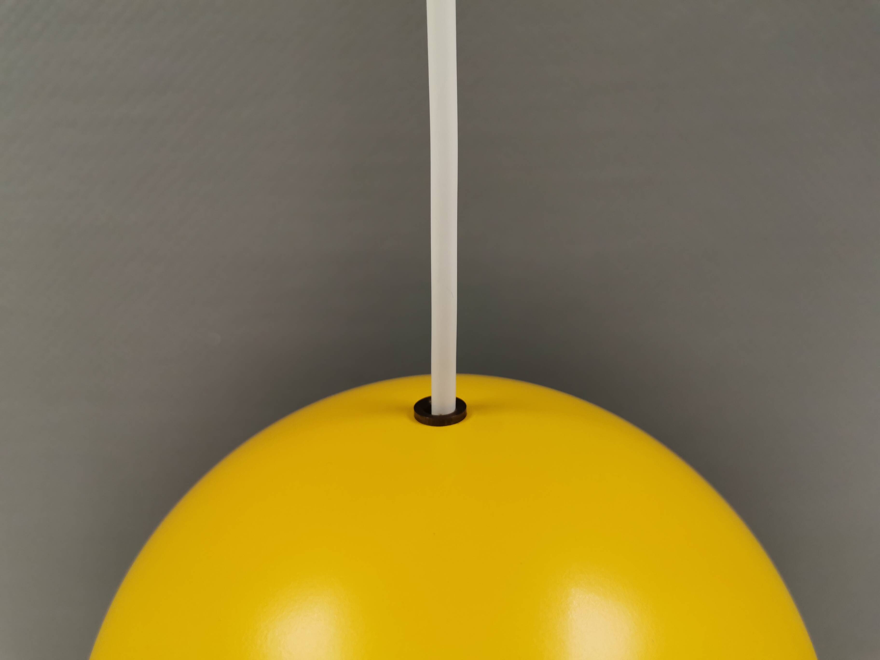 Spherical pendant lamp in sunny yellow.
