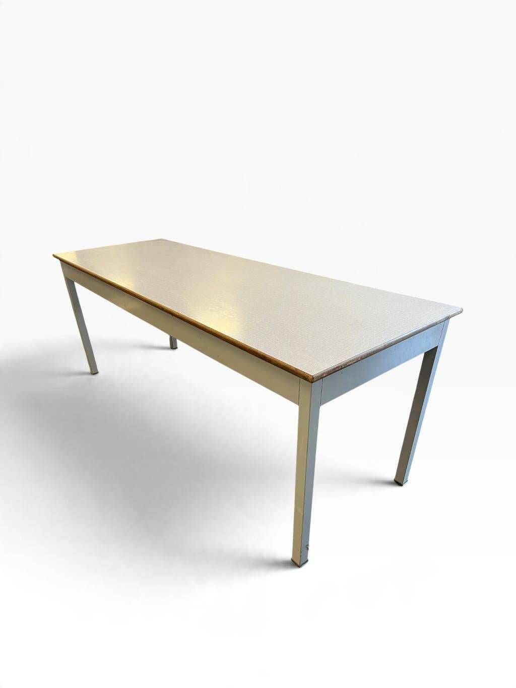 Vintage industrial table with a Formica top and wooden accents.