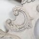 Large rococo fronton in stucco and carved wood, patinated white with an oculus.