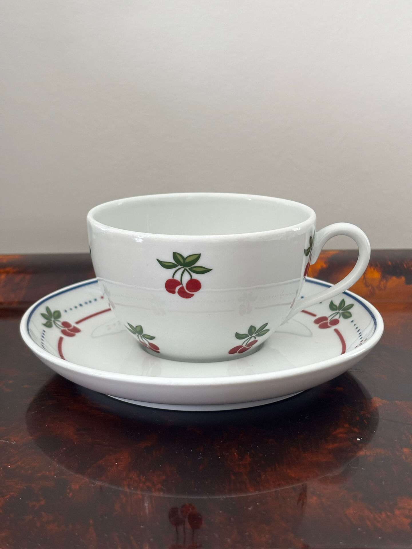 Magnificent teapot and fine porcelain cup set by Pillivuyt with cherries.