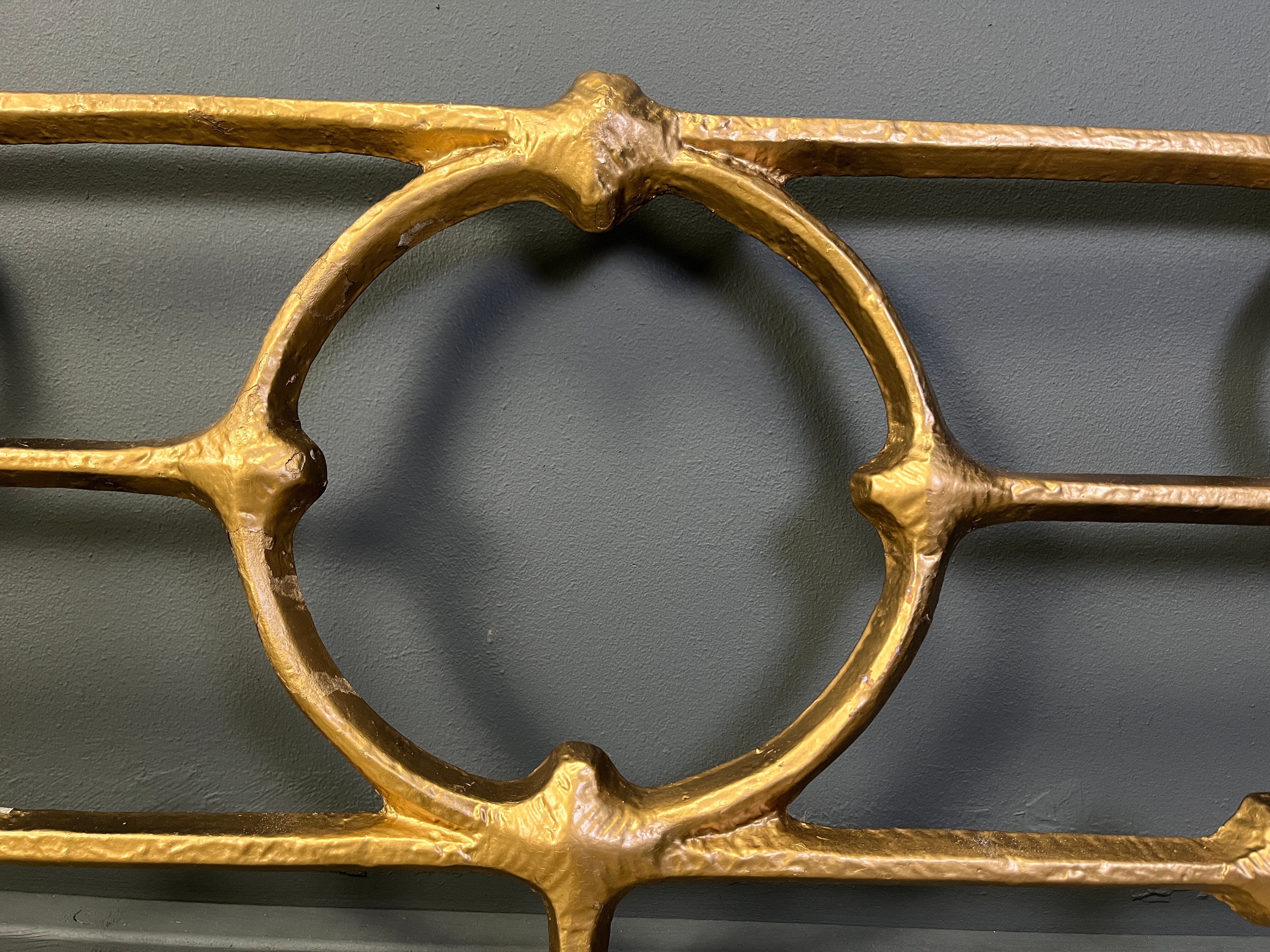 Architectural brutalist wall mounted sculpture made from cast metal.