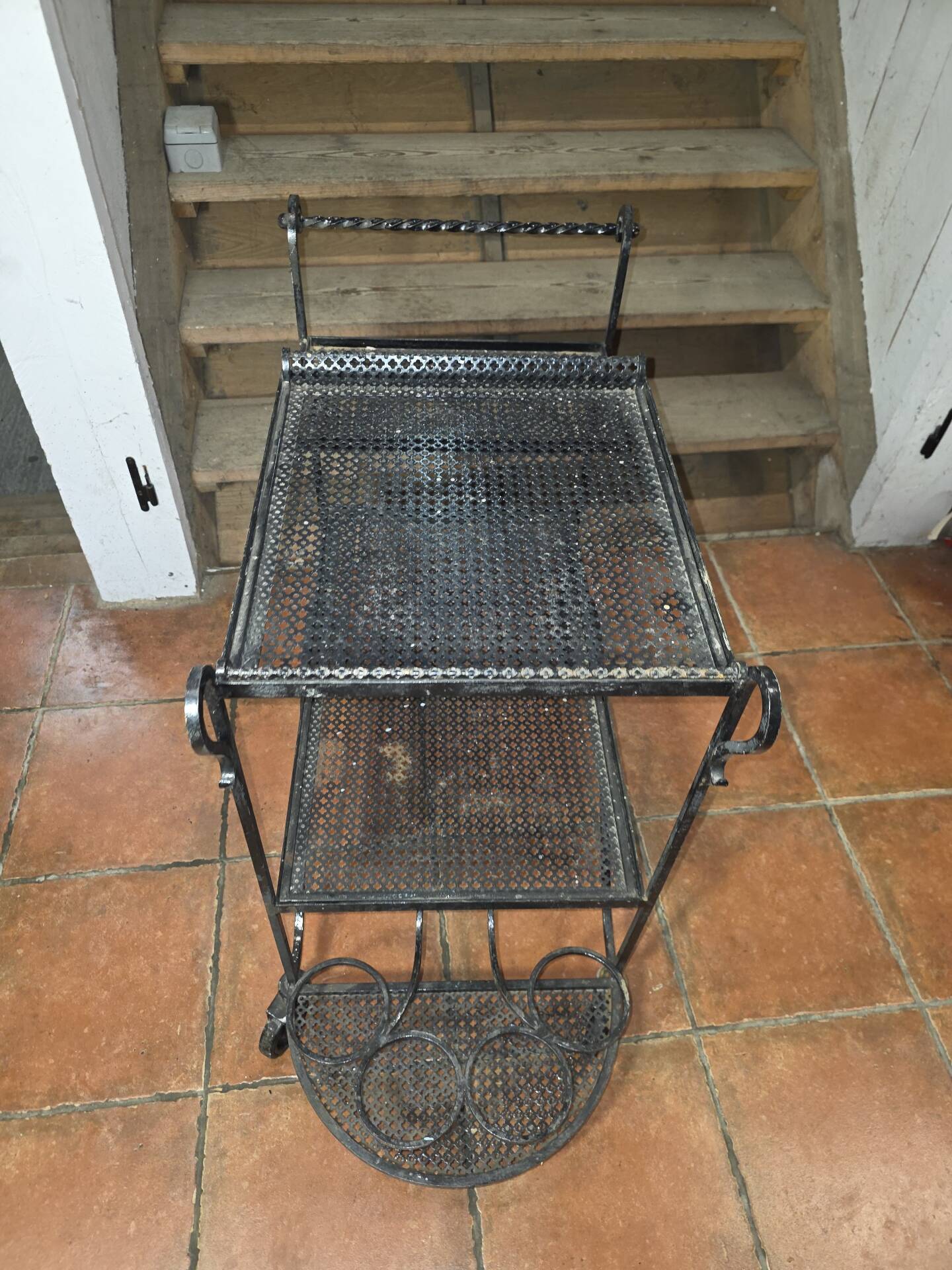 Perforated wrought iron rolling dessert trolley