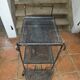 Perforated wrought iron rolling dessert trolley