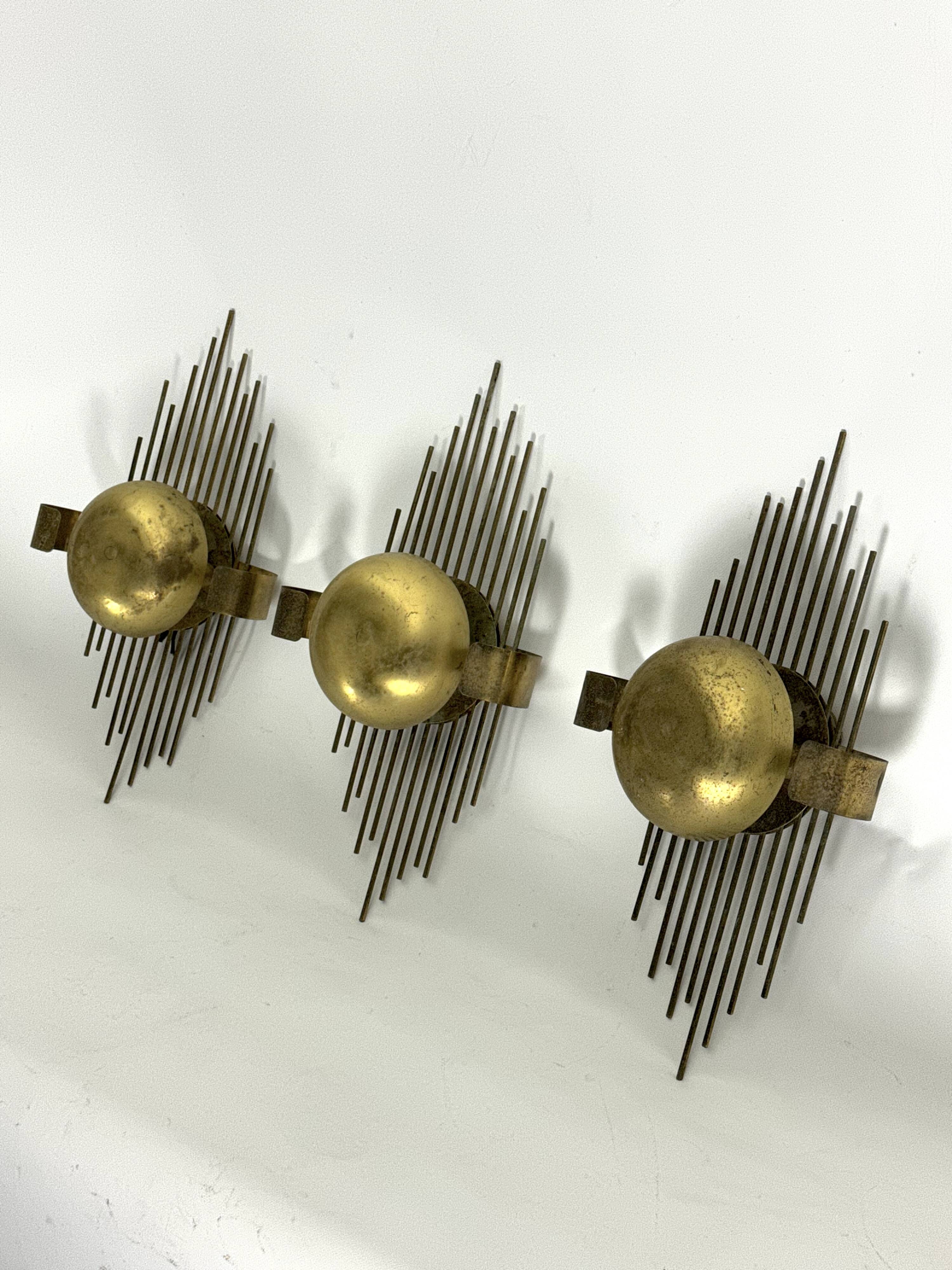 Mid-Century Set of three gilded metal sconces. Italy 1950s