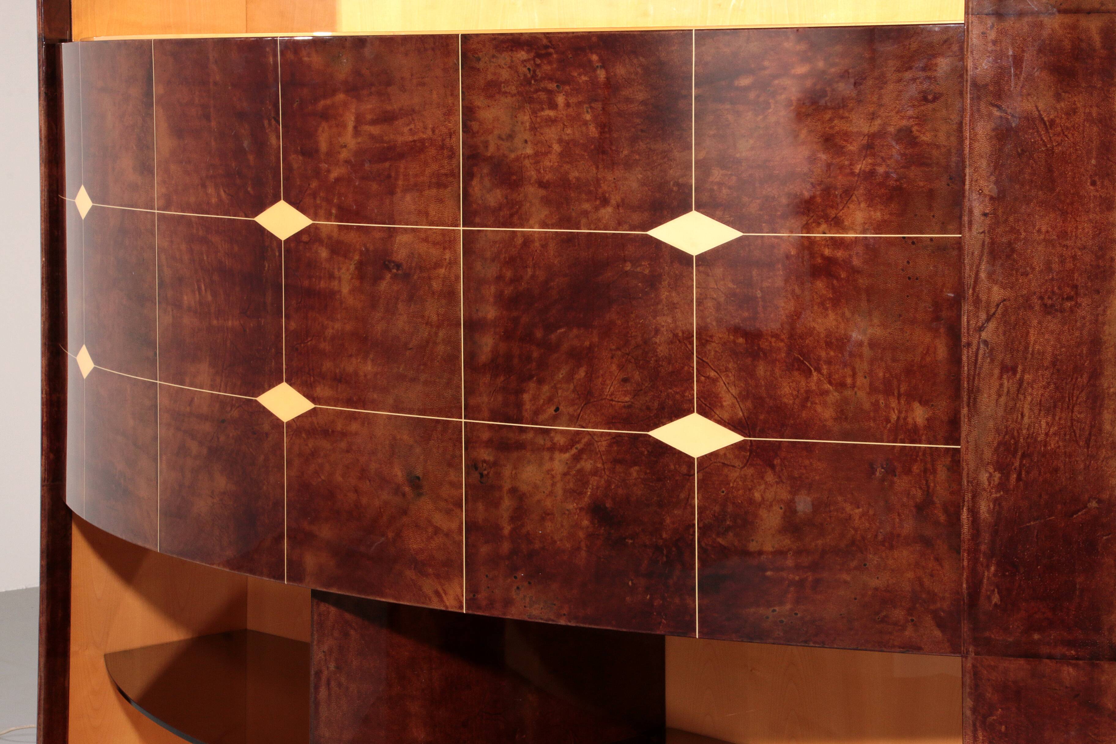 Iconic Aldo Tura brown goatskin bar cabinet with electric lift & mirror interior.