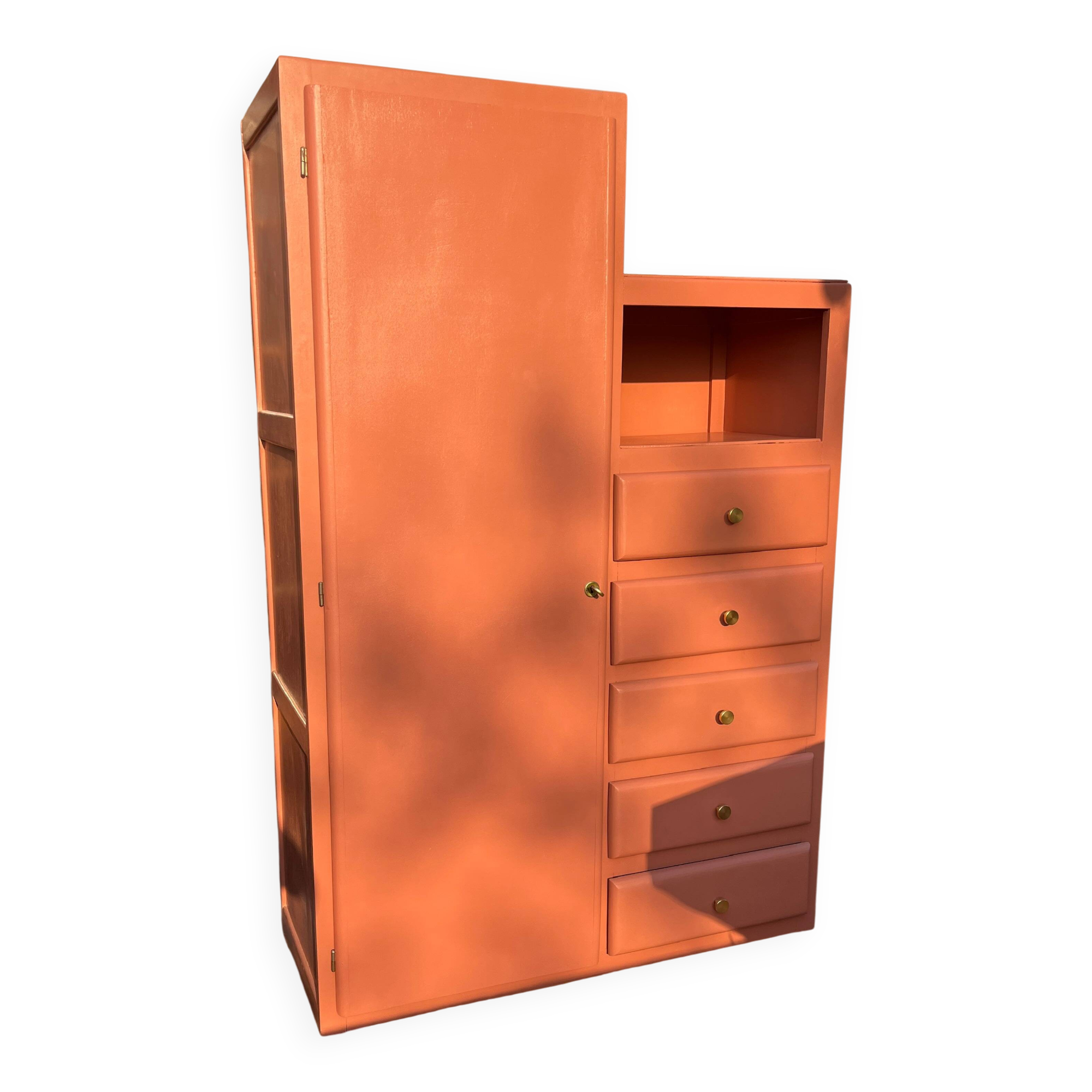 Asymmetrical vintage wardrobe painted in terracotta.