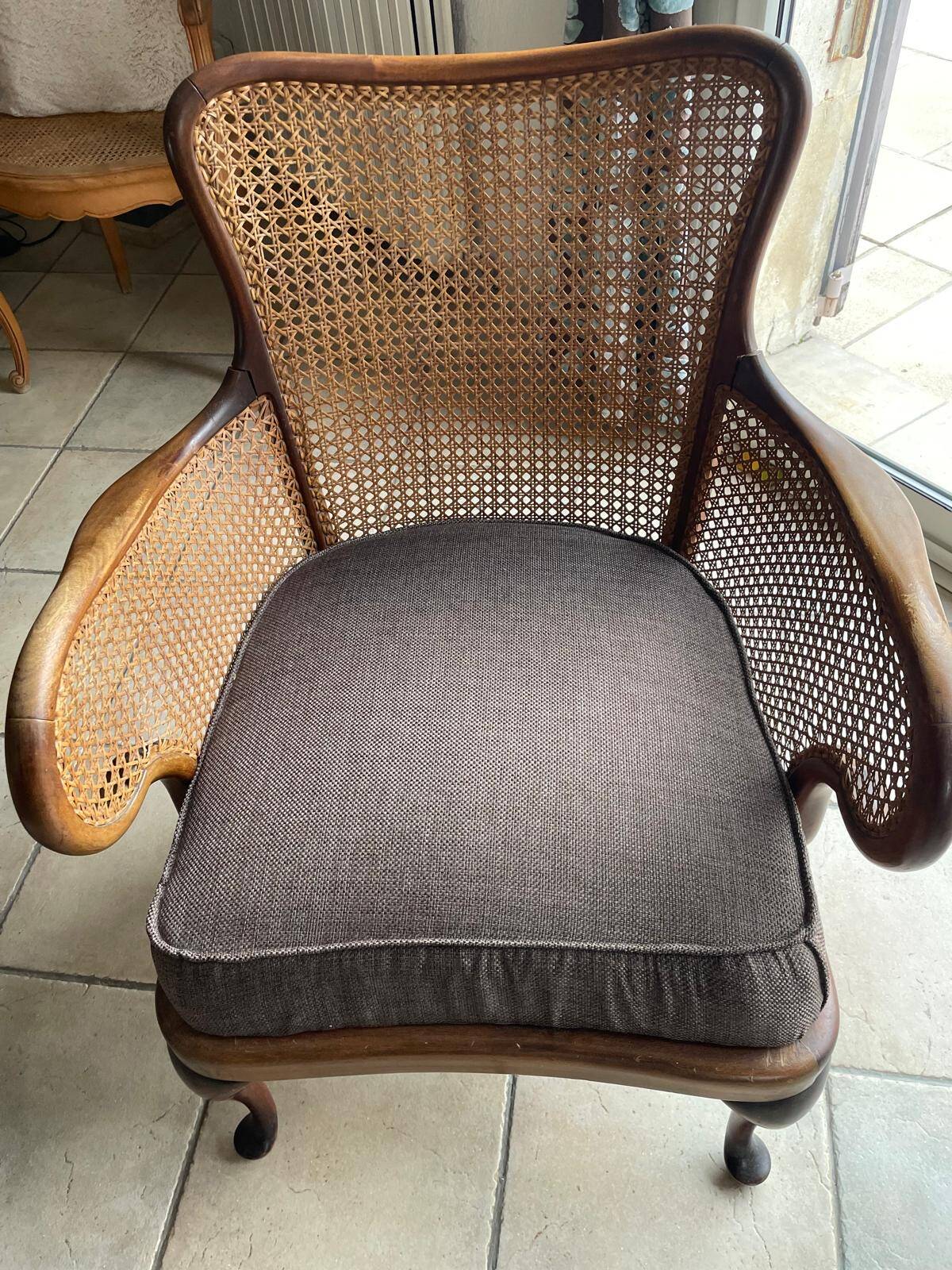 Chair with cane back and recently reupholstered fabric seat.