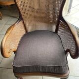 Chair with cane back and recently reupholstered fabric seat.
