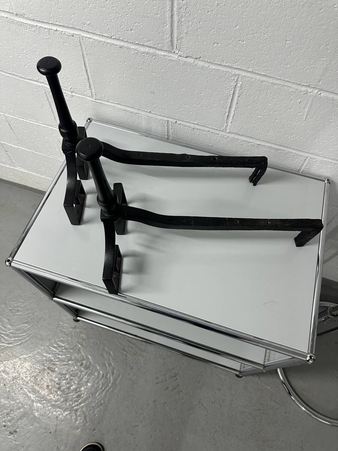 Pair of designer cast iron andirons