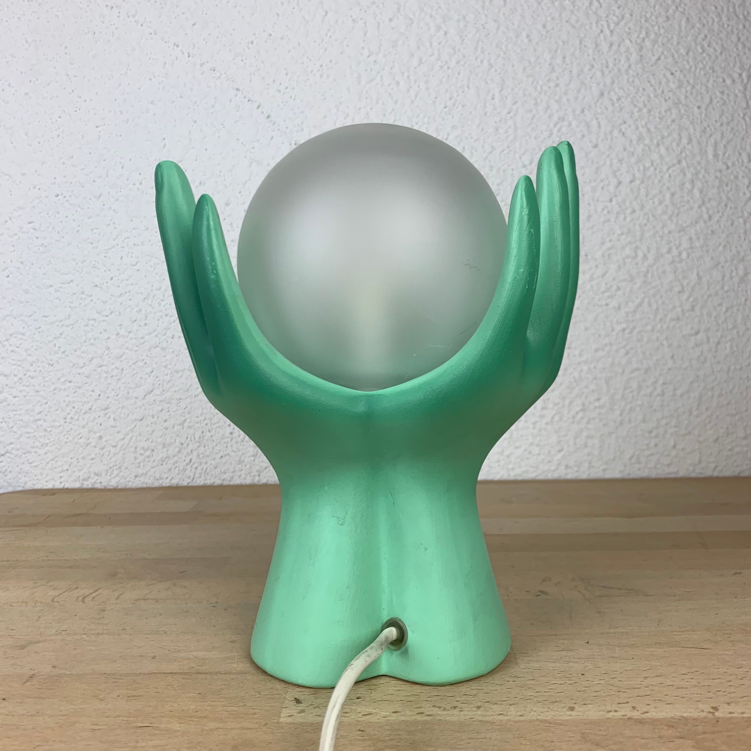 Green ceramic hand lamp and glass globe