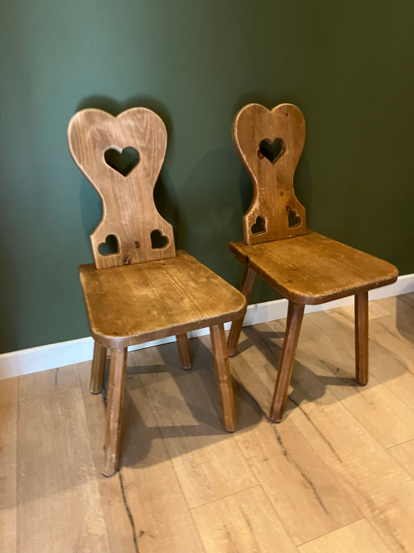 Pair of vintage wooden chairs in alpine chalet style.