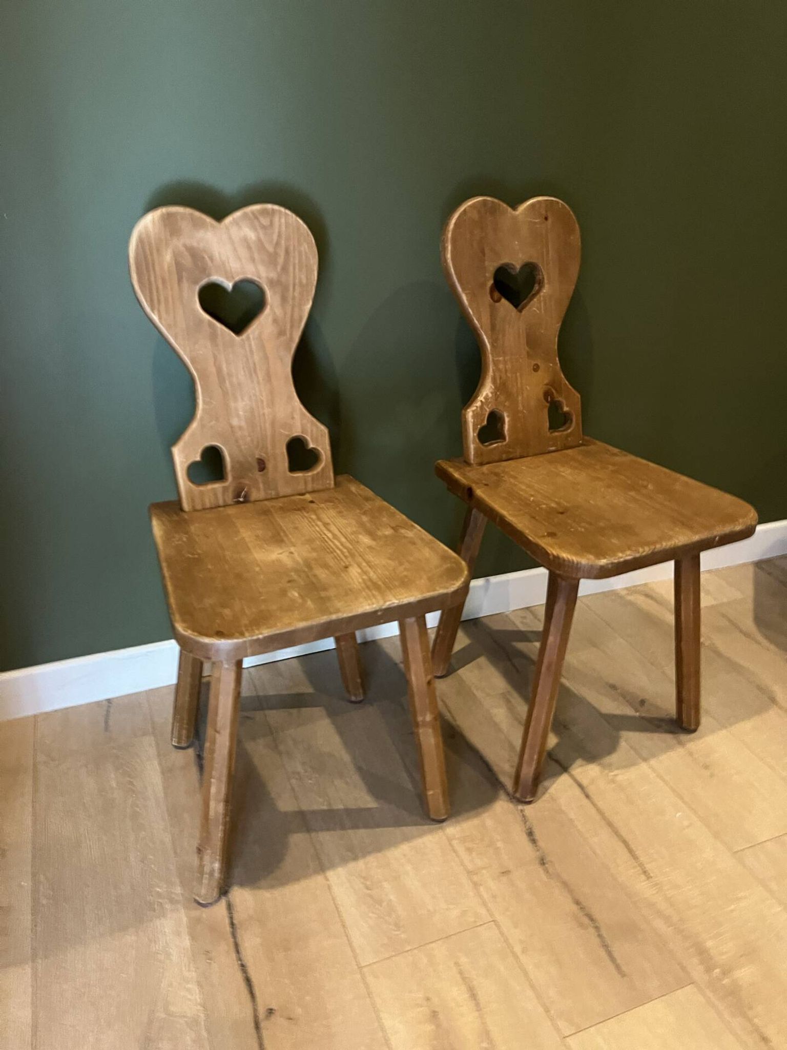 Pair of vintage wooden chairs in alpine chalet style.