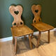 Pair of vintage wooden chairs in alpine chalet style.