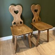 Pair of vintage wooden chairs in alpine chalet style.