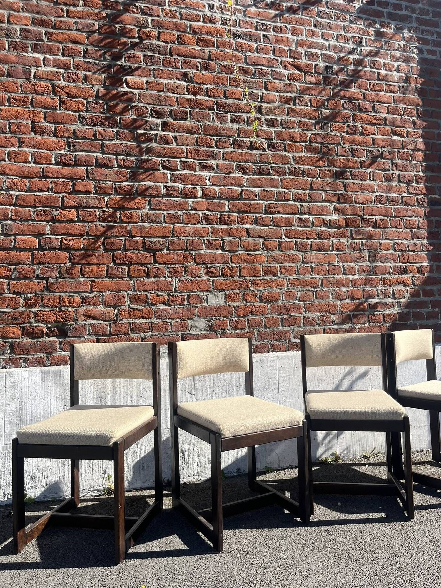 Many mid-century vintage wooden and fabric chairs.