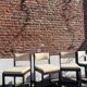 Many mid-century vintage wooden and fabric chairs.