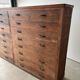 Large wooden workshop cabinet with 16 drawers, antique from the early 1900s.