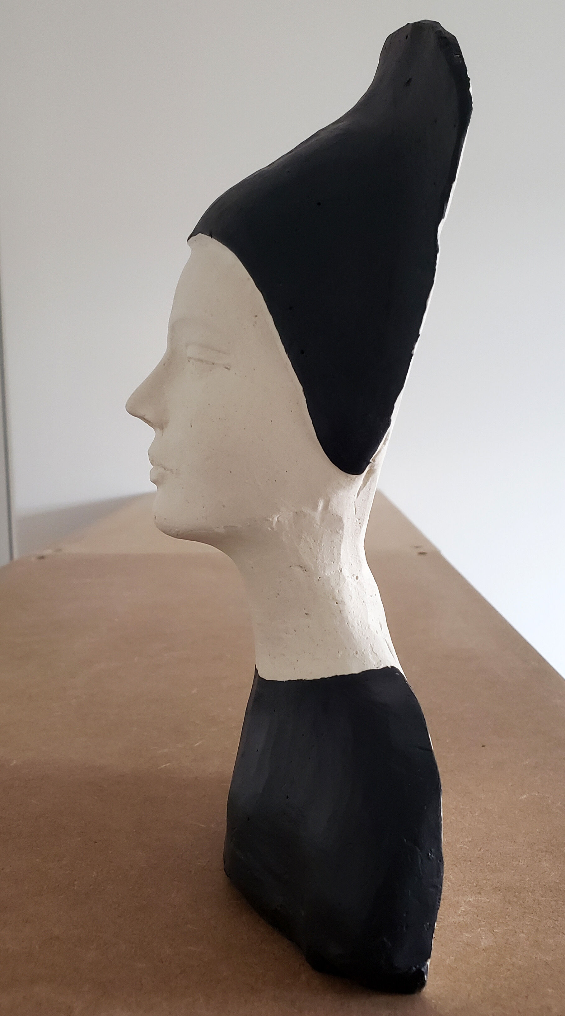Bust of a woman in anthracite and white plaster