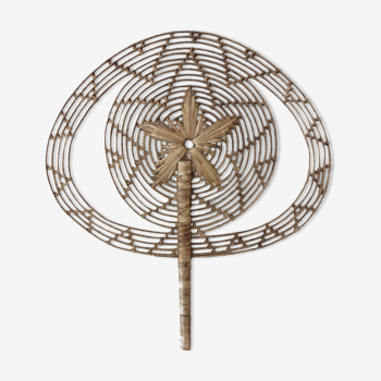 Vintage fan in palm leaves
