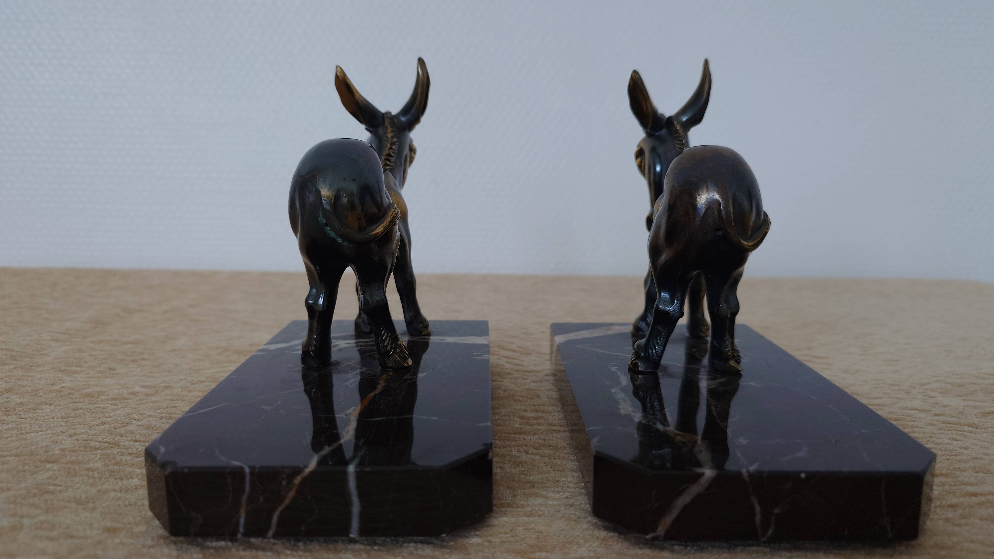 Bookends in the style of stylised donkeys, patinated metal and marble - circa 1940-1950.