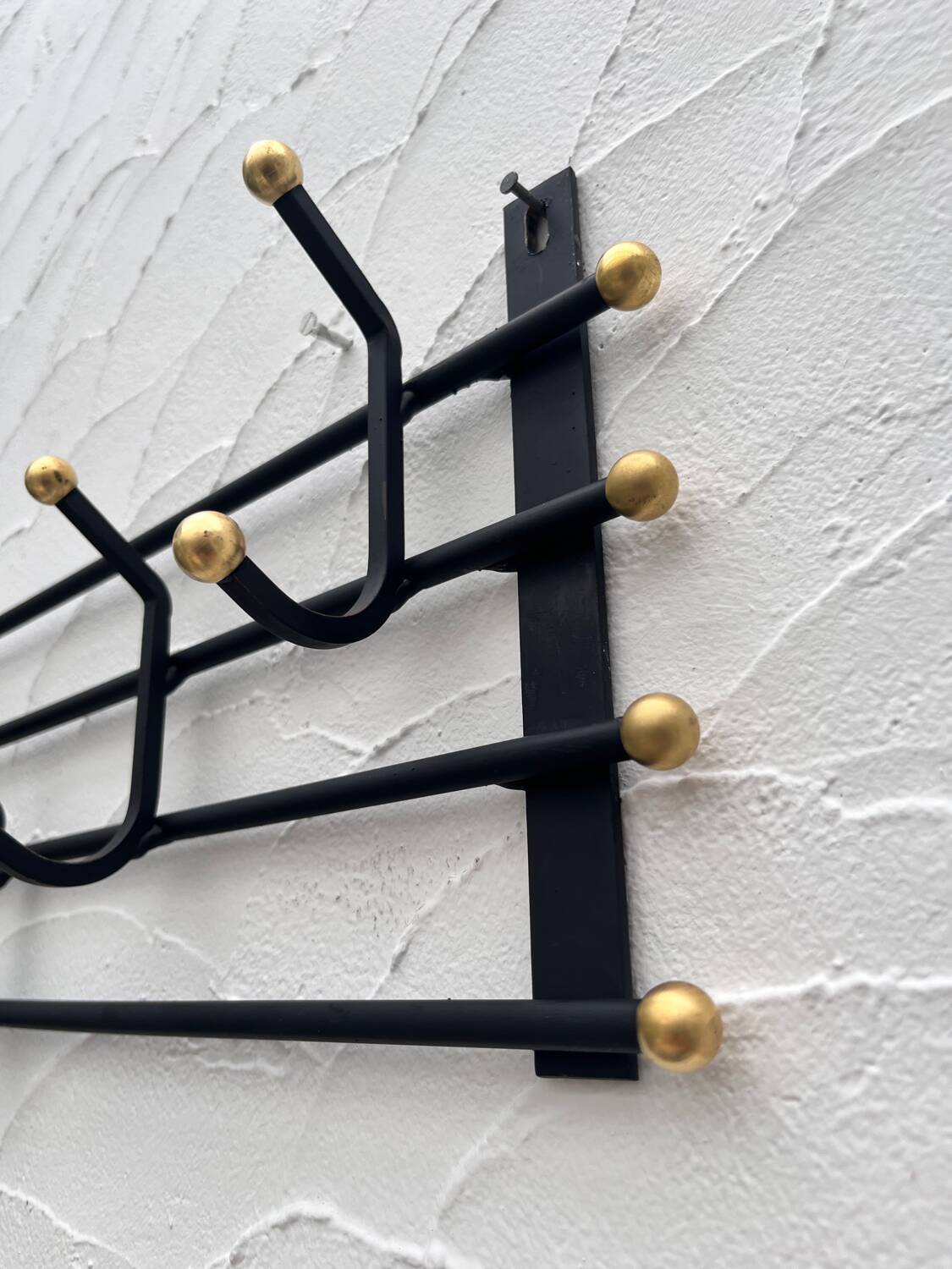 Iron and brass coat rack