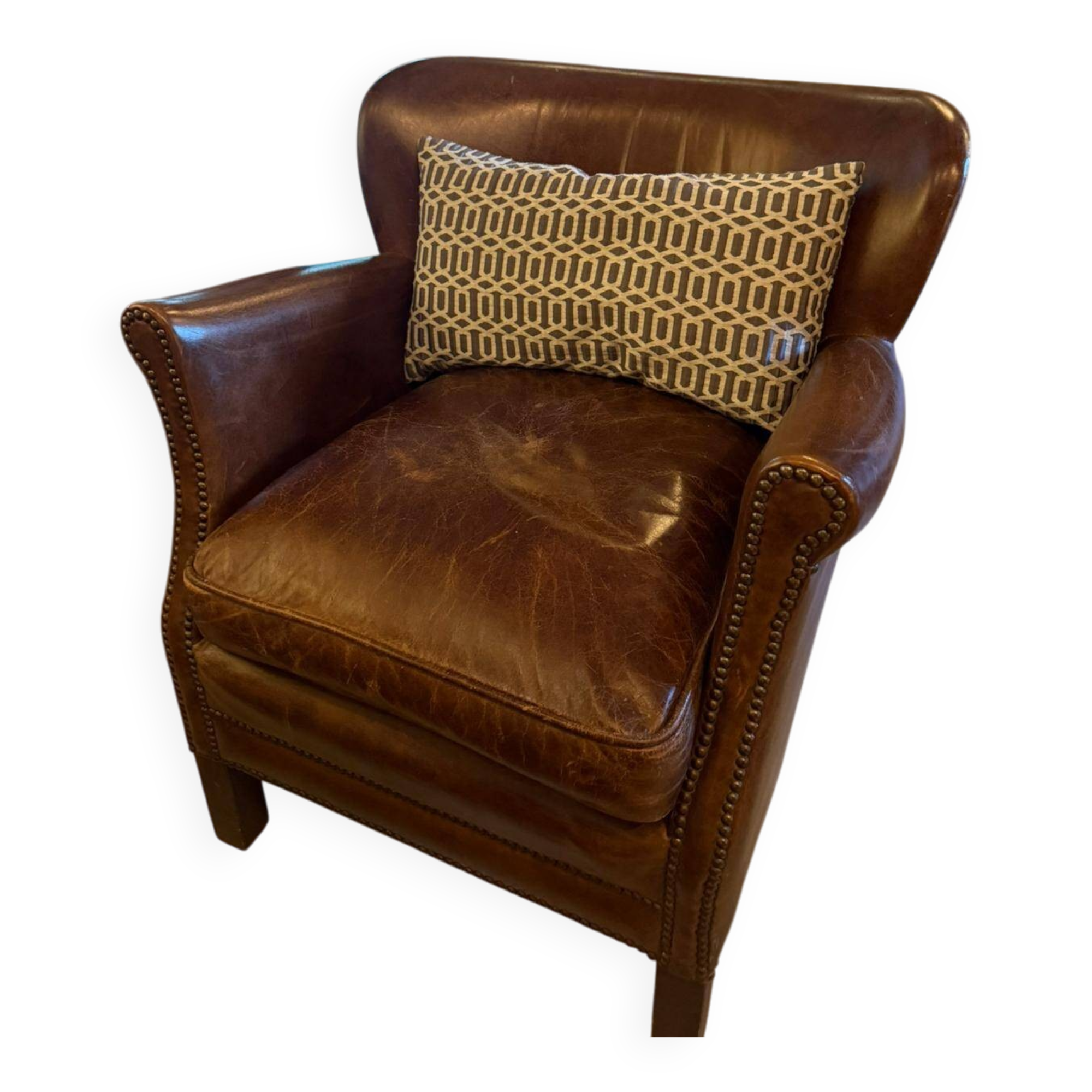 Brown cowhide armchair with a reversible seat cushion in KELIM.