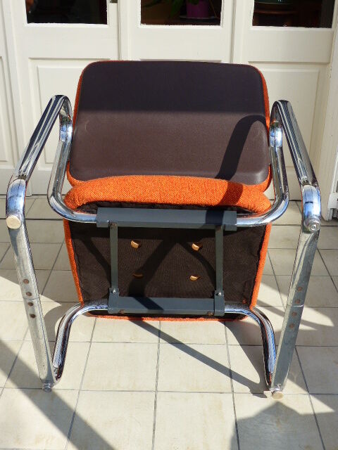The 1970s orange armchair fabric and chrome metal