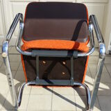 The 1970s orange armchair fabric and chrome metal
