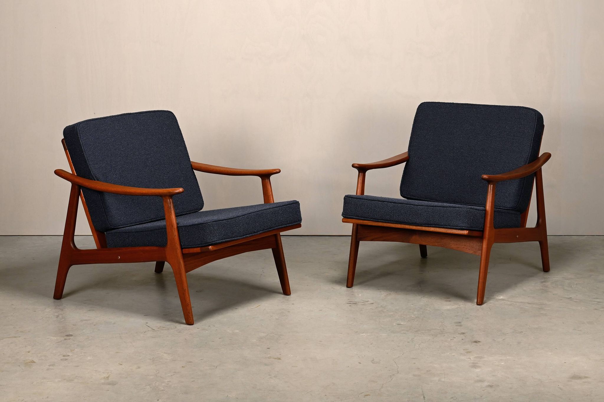 Pair Scandinavian Modern armchairs in teak and dark blue bouclé fabric