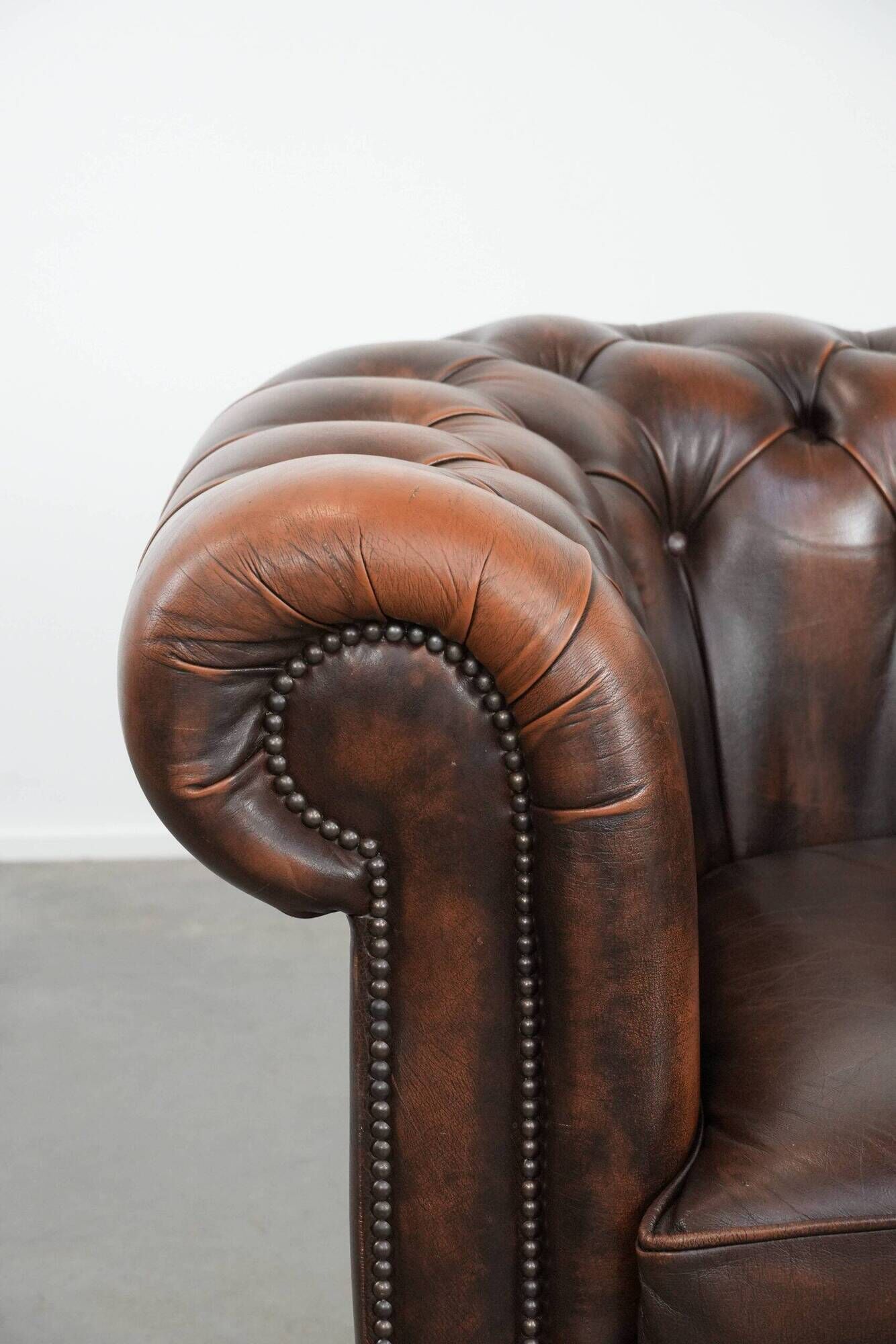 Brown Chesterfield armchair made of cowhide leather in English style