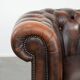 Brown Chesterfield armchair made of cowhide leather in English style