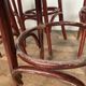 Series of 9 bistro bar stools in curved wooden restaurant sitting red fabric