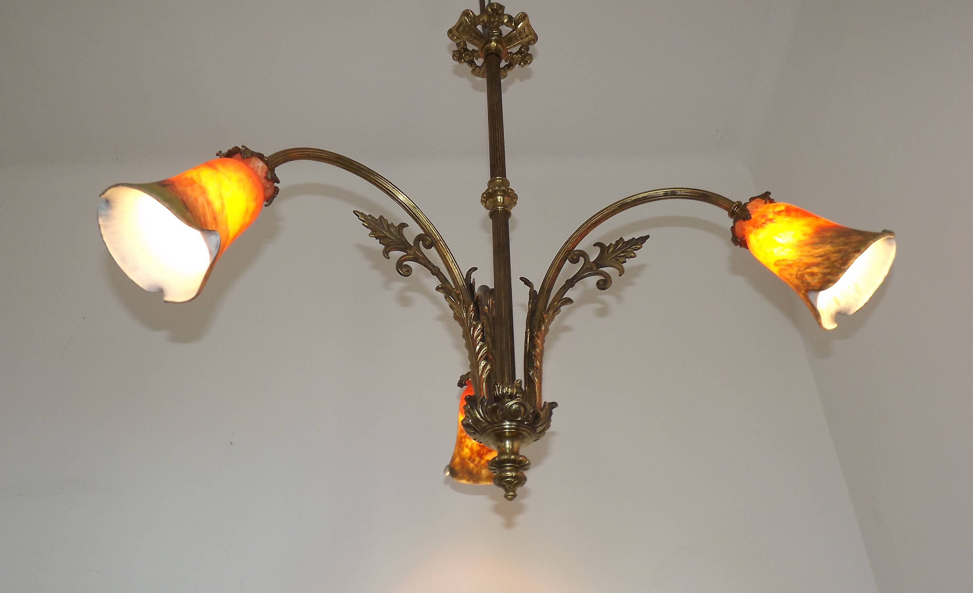 Art Nouveau three-light chandelier in bronze with orange and green glass shade, France.