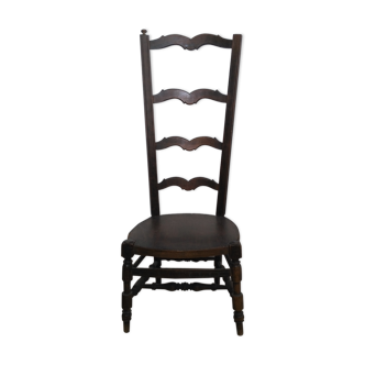 Low chair with high back called fire corner chair or nanny chair