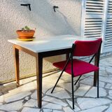 Vintage oak farmhouse table with a white top.