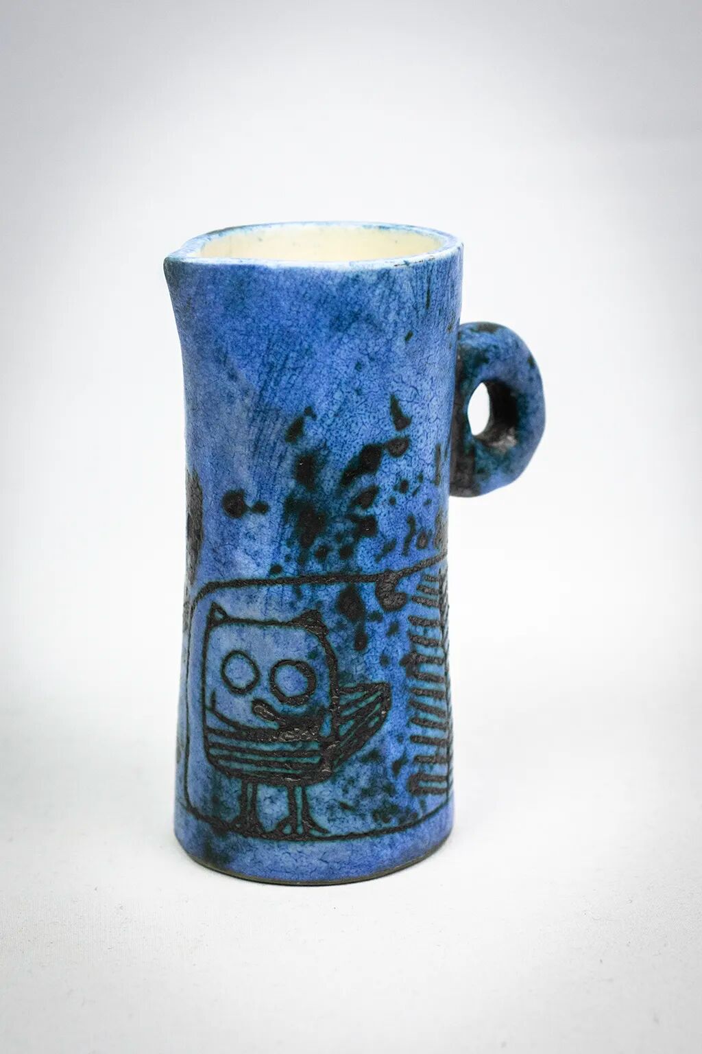 Small jug by Jacques Blin in blue ceramic with engraved animal decoration.