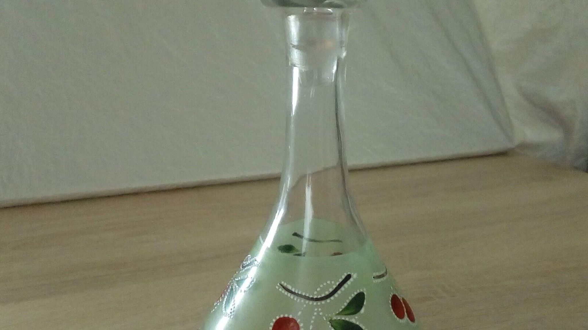 Glass carafe with enamel decoration of cherries.