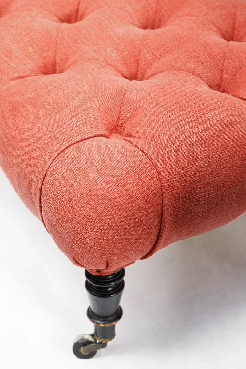 Napoleon III salon armchair in brick red linen with a tufted footrest.