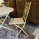 Foldable garden or terrace furniture set made of sheet metal and woven, perforated wrought iron, 5 pieces.