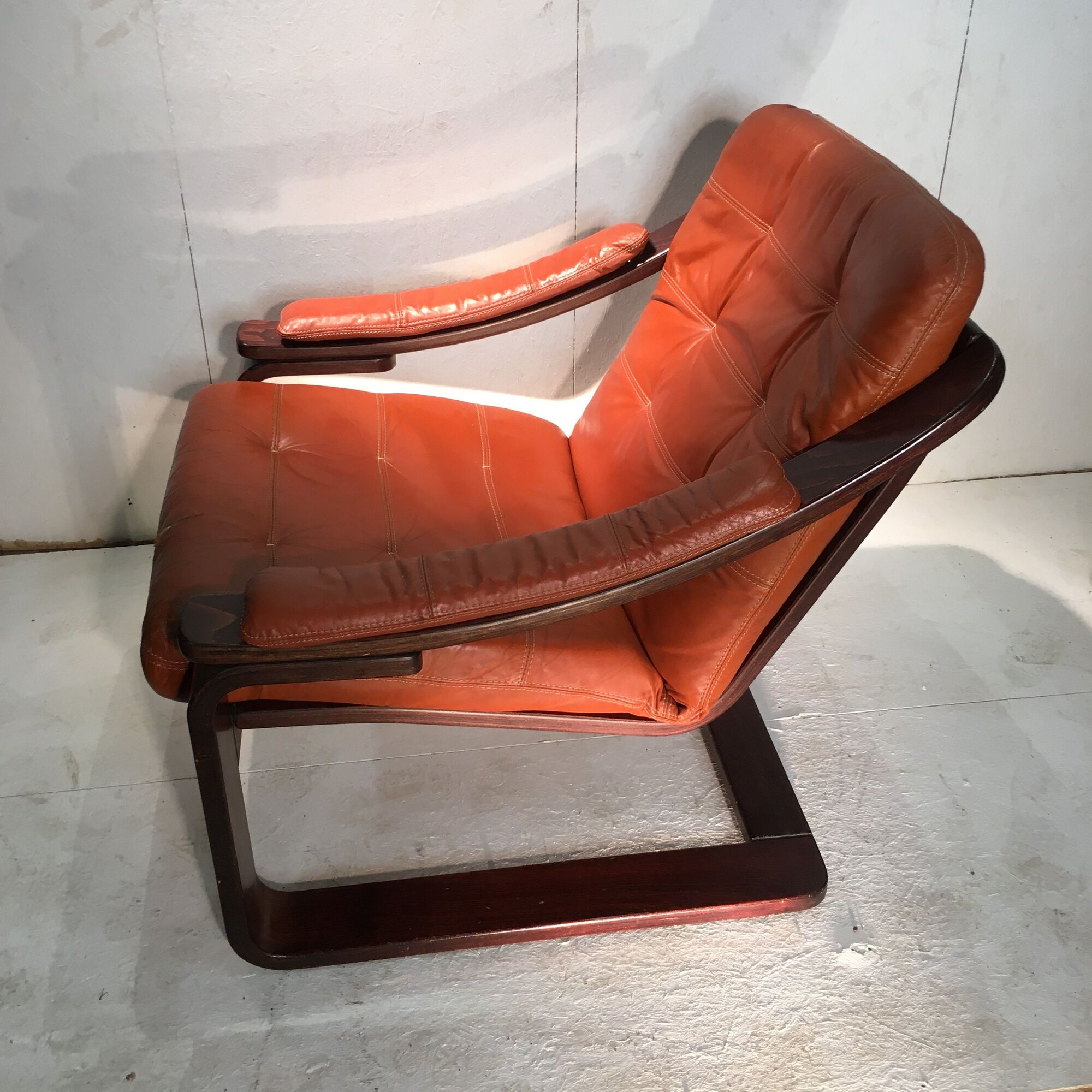 Duo of ochre leather and wood frame armchairs