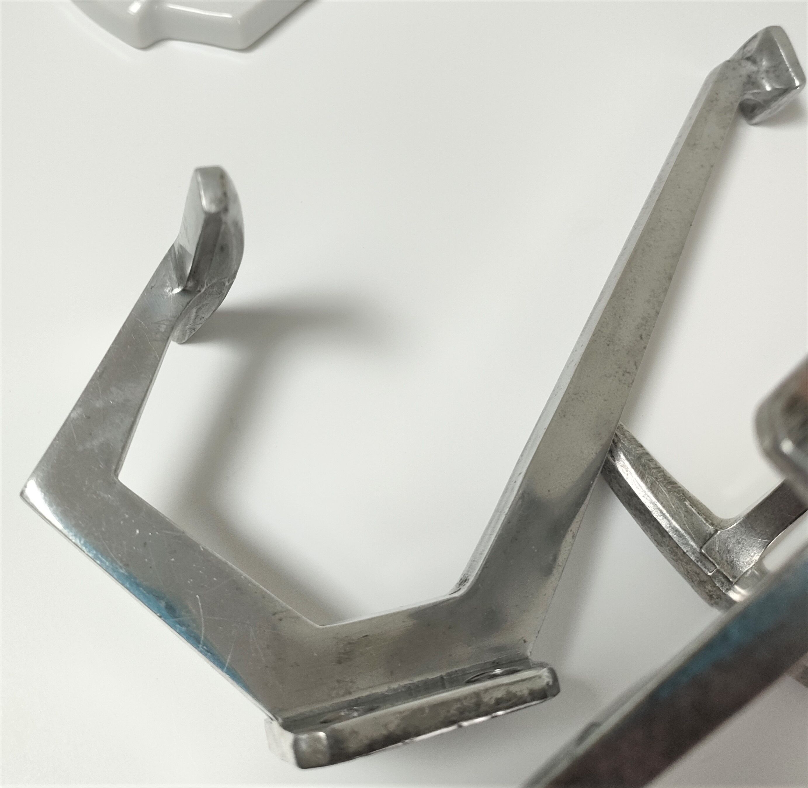 Four porcelain and vintage aluminum hooks