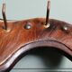 Wooden coat rack, nails & cowhide