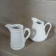 2 small white porcelain pitchers