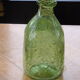 Biot stamped blown glass bottle