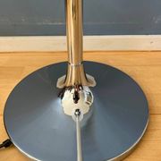 Guzzini Flash Space Age floor lamp with a chrome base and white acrylic shade.